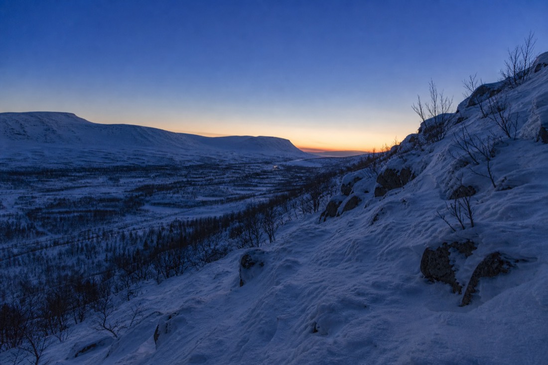 Blue hour over a Lapland valley, snow holding the last light
